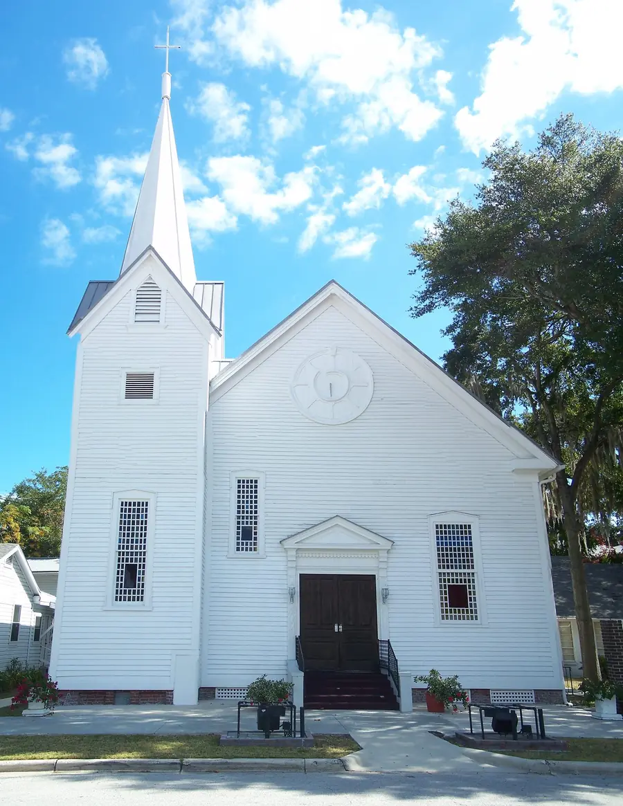 The white wood-frame sanctuary of First Missionary Baptist Church with its tall steeple